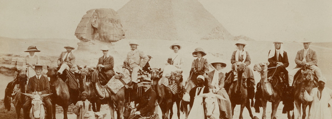 vintage photo of travelers on camels at the Pyramids of Egypt