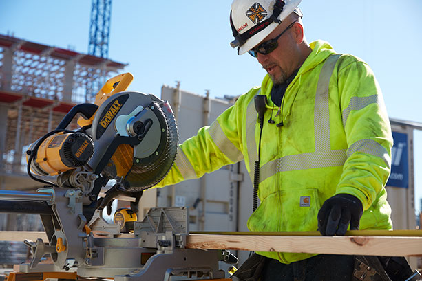 Graham employee using a saw on site.
