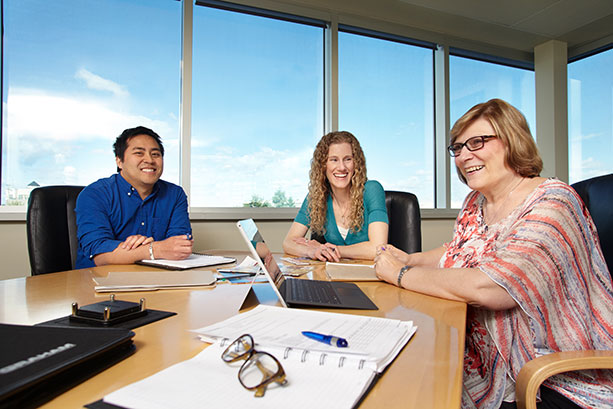Employees in a team meeting at Graham Corporate Office.