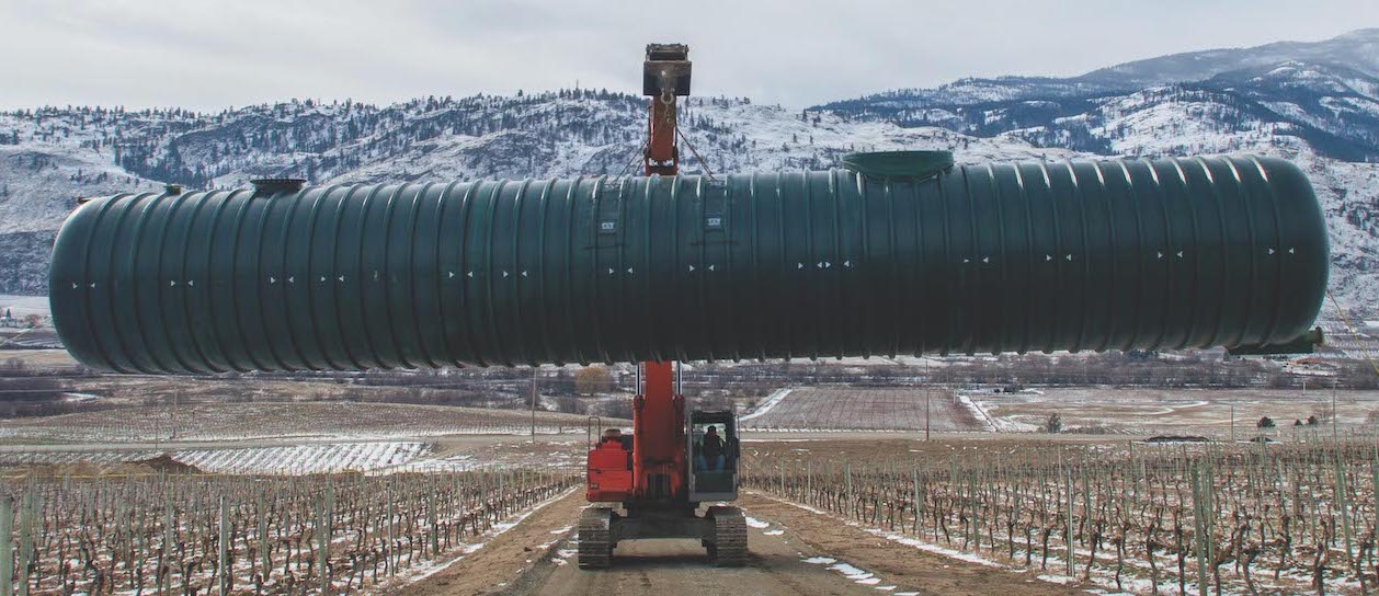 tractor moving large pipe