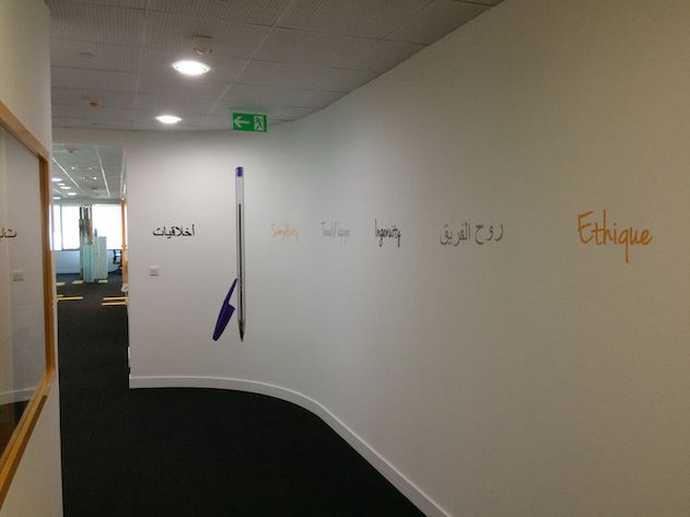 Hallway with BIC corporate values painted on the wall.
