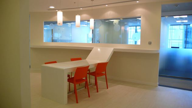 Kitchen area with orange chairs.