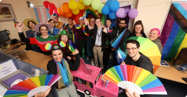 A group of staff members celebrating LGBTQIA+ diversity.